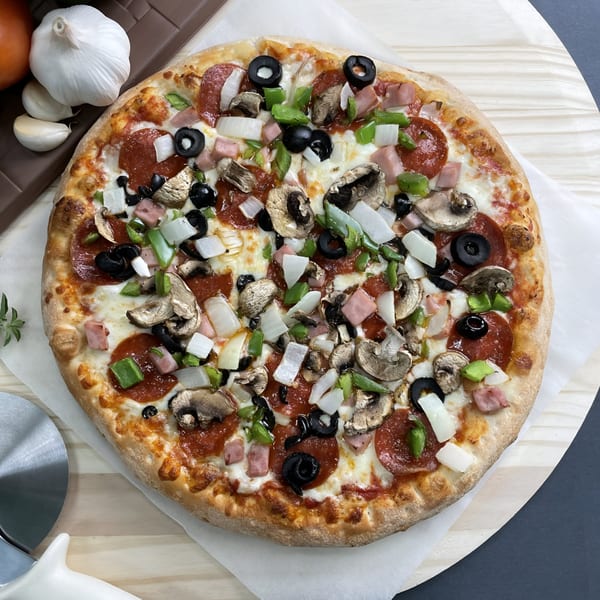 Big T's Pizza with pepperoni, ham, mushrooms, olives, green peppers, and onions.